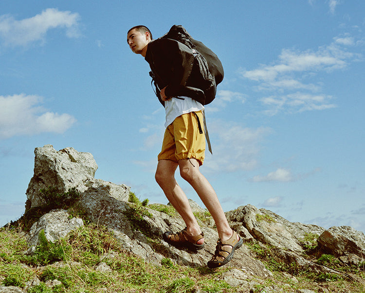 Man with backpack hiking in Newport sandals
